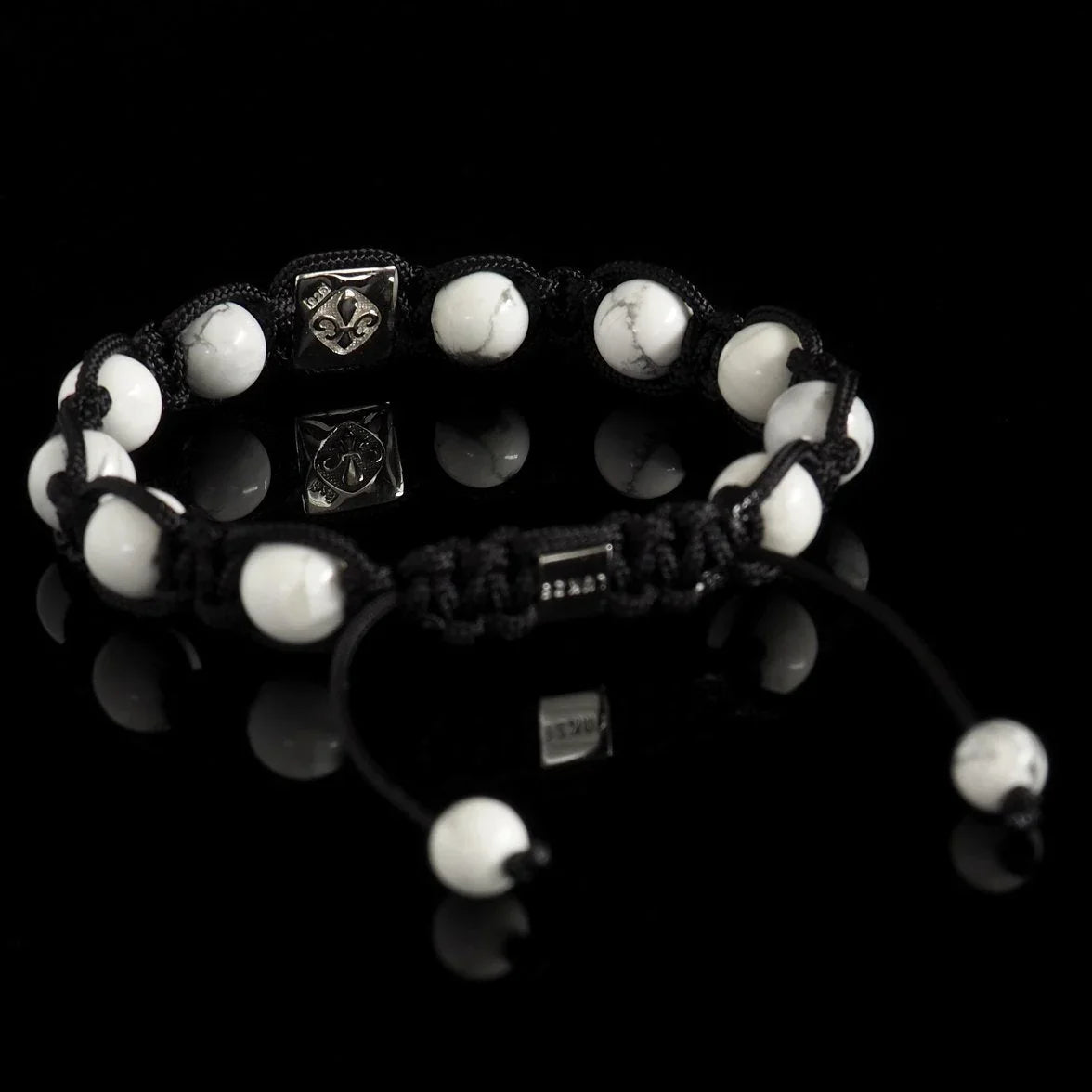 Lukze Howlite and Diamond Shamballa bracelet with white beads and black cord on black background