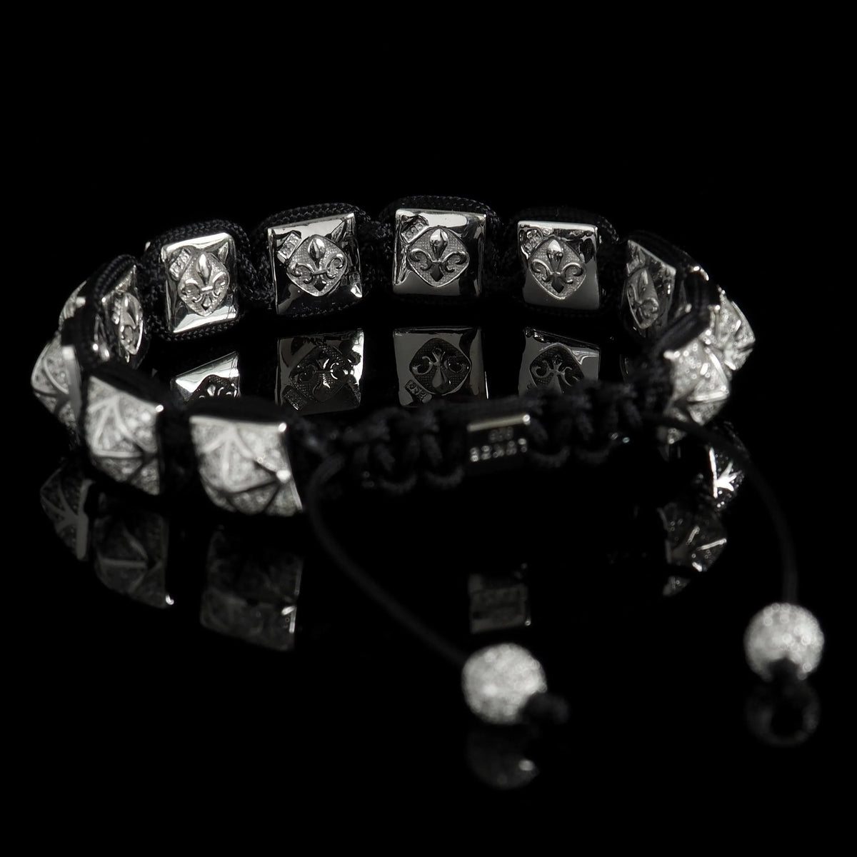 Stargazer Shamballa Bracelet by Lukze featuring silver fleur-de-lis beads on a black cord.