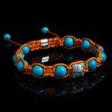 Lukze turquoise and diamond Shamballa bracelet with orange cord on black background