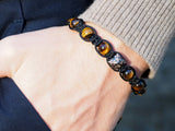 Lukze Champagne CZ Diamond and Yellow Tiger's Eye Shamballa bracelet on a wrist