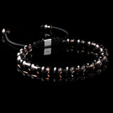 Lukze Onyx and Smokey Quartz macramé bracelet with 925 silver bead on black background